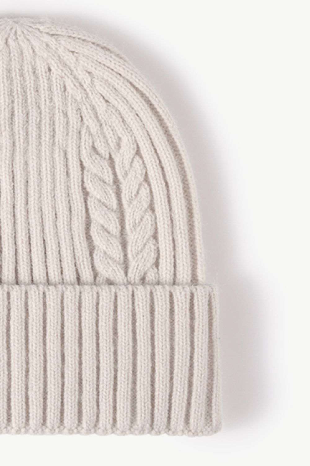 Side view of white Cable-Knit Cuff Beanie, showcasing the textured knit pattern and fold-over cuff, perfect for a warm and stylish winter look.