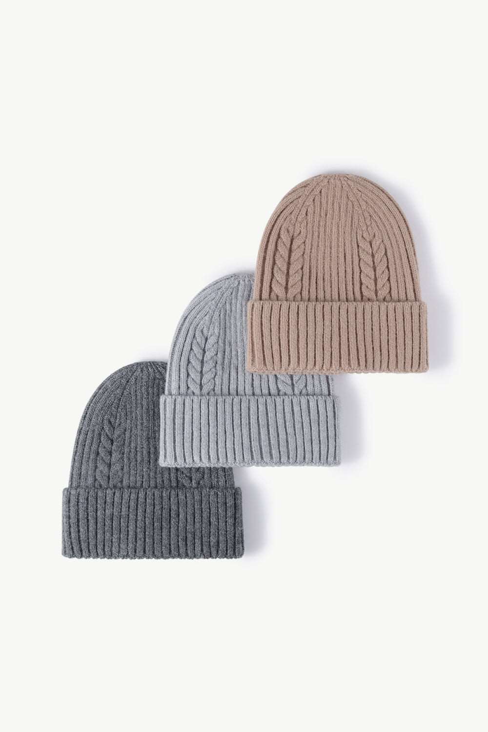 Dark gray, gray, and beige Cable-Knit Cuff Beanies displayed together, offering versatile, neutral color options with cozy textured knit and fold-over cuffs for a stylish winter look.