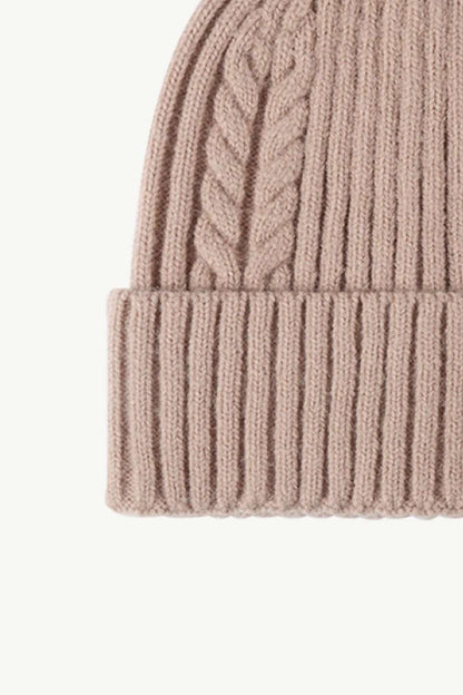 Lower left side view of beige Cable-Knit Cuff Beanie, emphasizing the textured knit pattern and fold-over cuff for a cozy, stylish winter accessory.