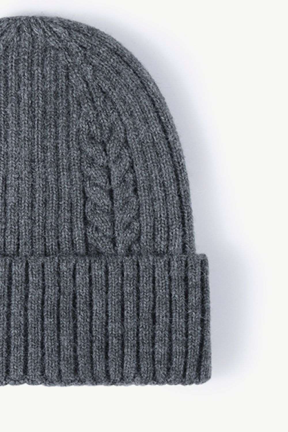 Side view of dark gray Cable-Knit Cuff Beanie, showcasing the textured knit pattern and fold-over cuff for a warm, stylish winter look.