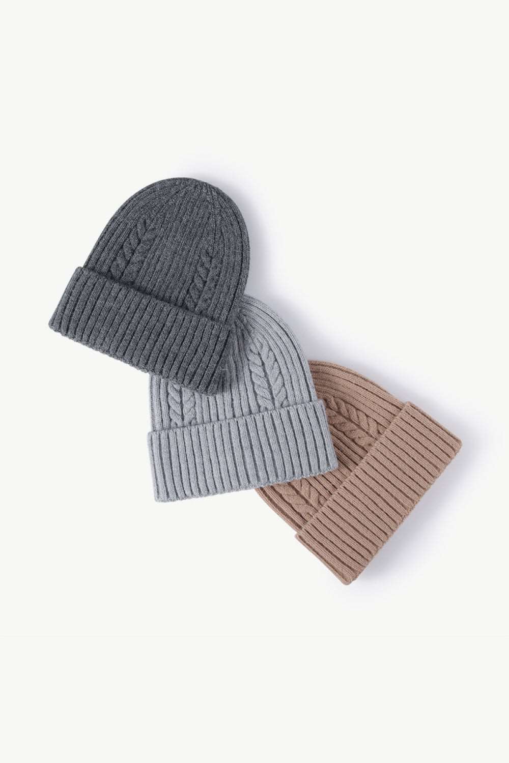 Dark gray, gray, and beige Cable-Knit Cuff Beanies displayed side by side, highlighting the versatile, neutral color options with cozy textured knit and fold-over cuffs.