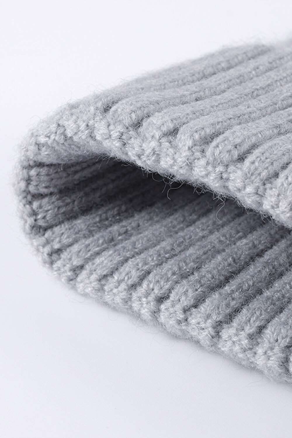 Close-up of Cable-Knit Cuff Beanie highlighting the intricate textured knit pattern and fold-over cuff, showcasing the high-quality craftsmanship and cozy winter style. - Gray 